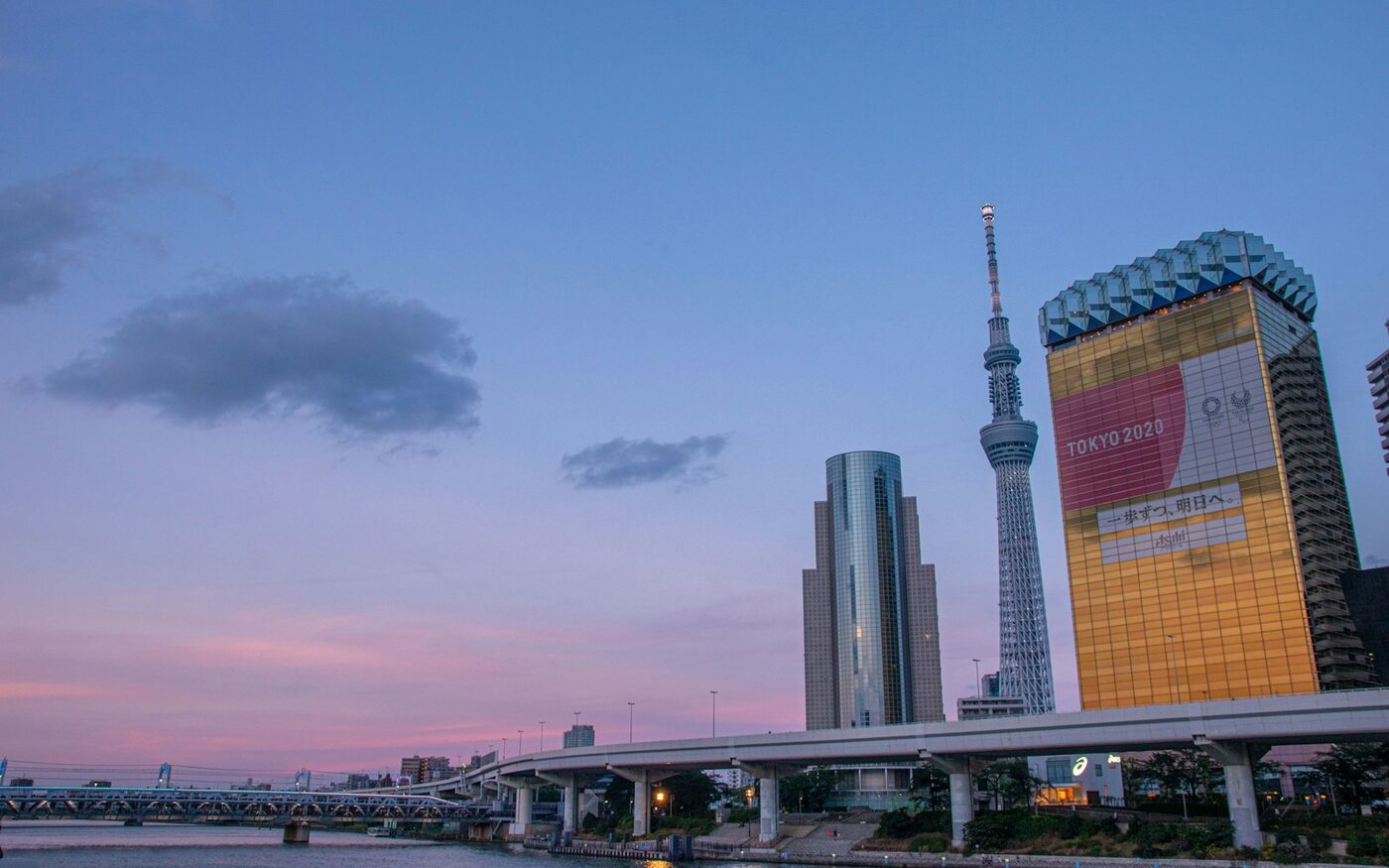Tokyo Skytree and riverside buildings beneath an evening sky