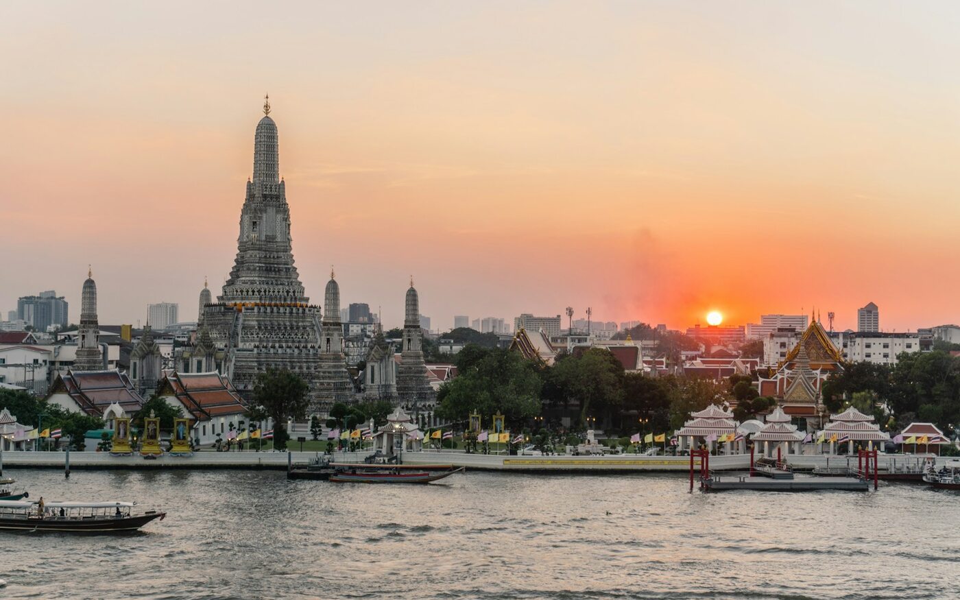 Wat Arun temple beside the Chao Phraya River in Bangkok at sunset